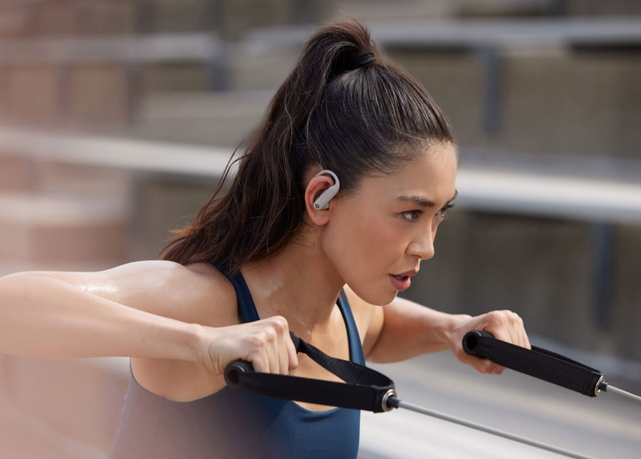 Woman wearing Powerbeats Pro 2 while working out to demonstrate secure fit.
