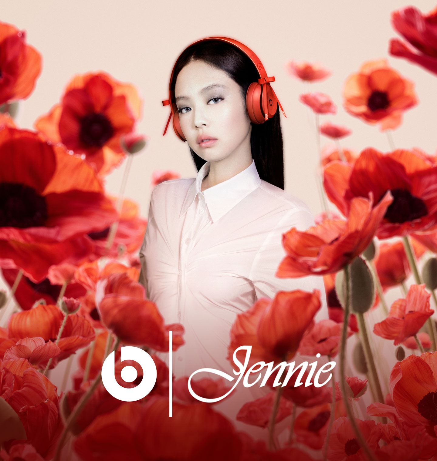 Jennie wearing her collaboration Beats Solo 4 headphones in Ruby Red against a backdrop of blurred red poppies.