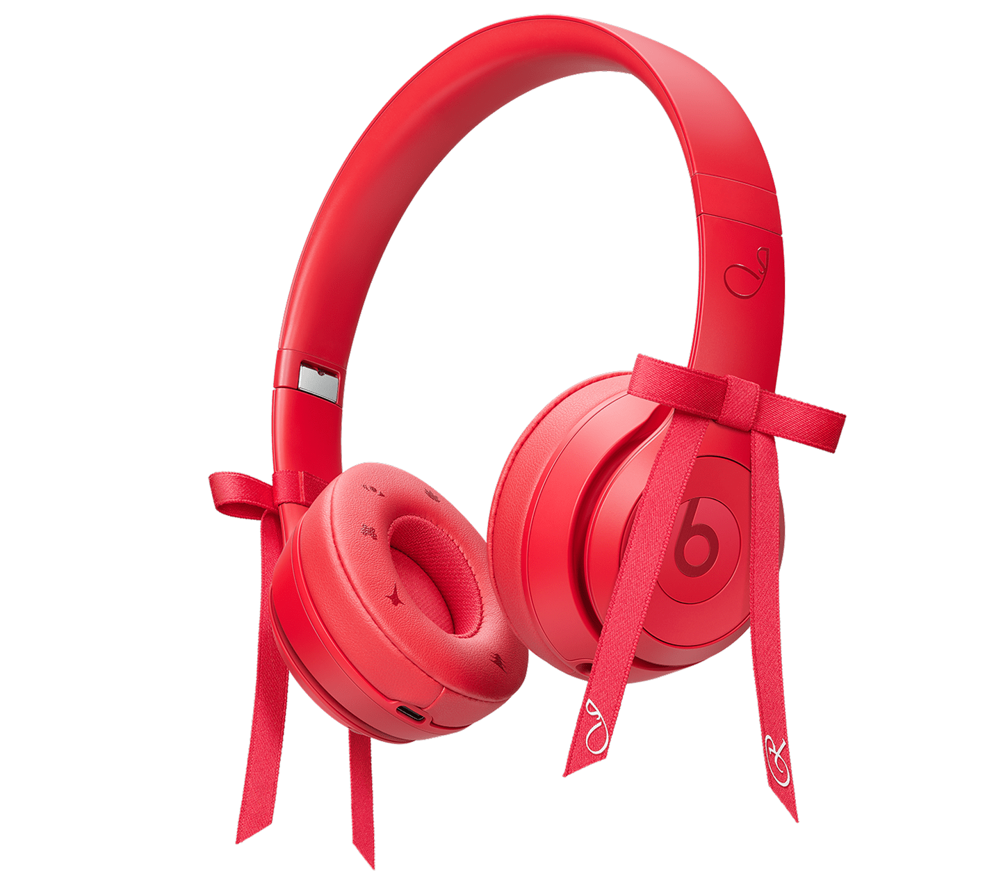 Angled right view of the Beats Solo 4 - JENNIE Special Edition headphones in Ruby Red, with two attachable red bows.
