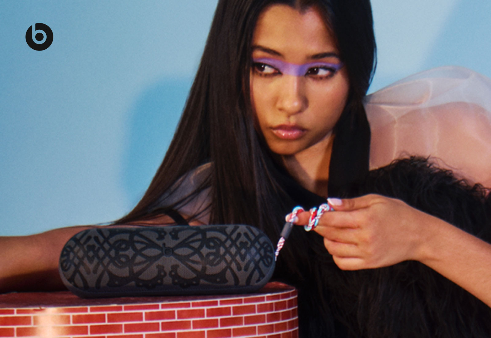 BB Trickz posing with the limited-edition Kiko Kostadinov Beats Pill with its colourful braided lanyard