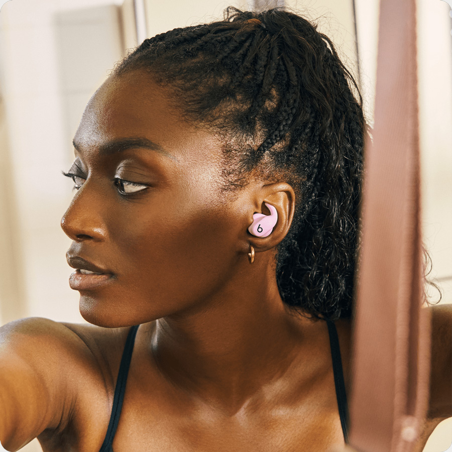 Close-up of Powerbeats Fit earbuds showing the flexible, secure-fit wing tips