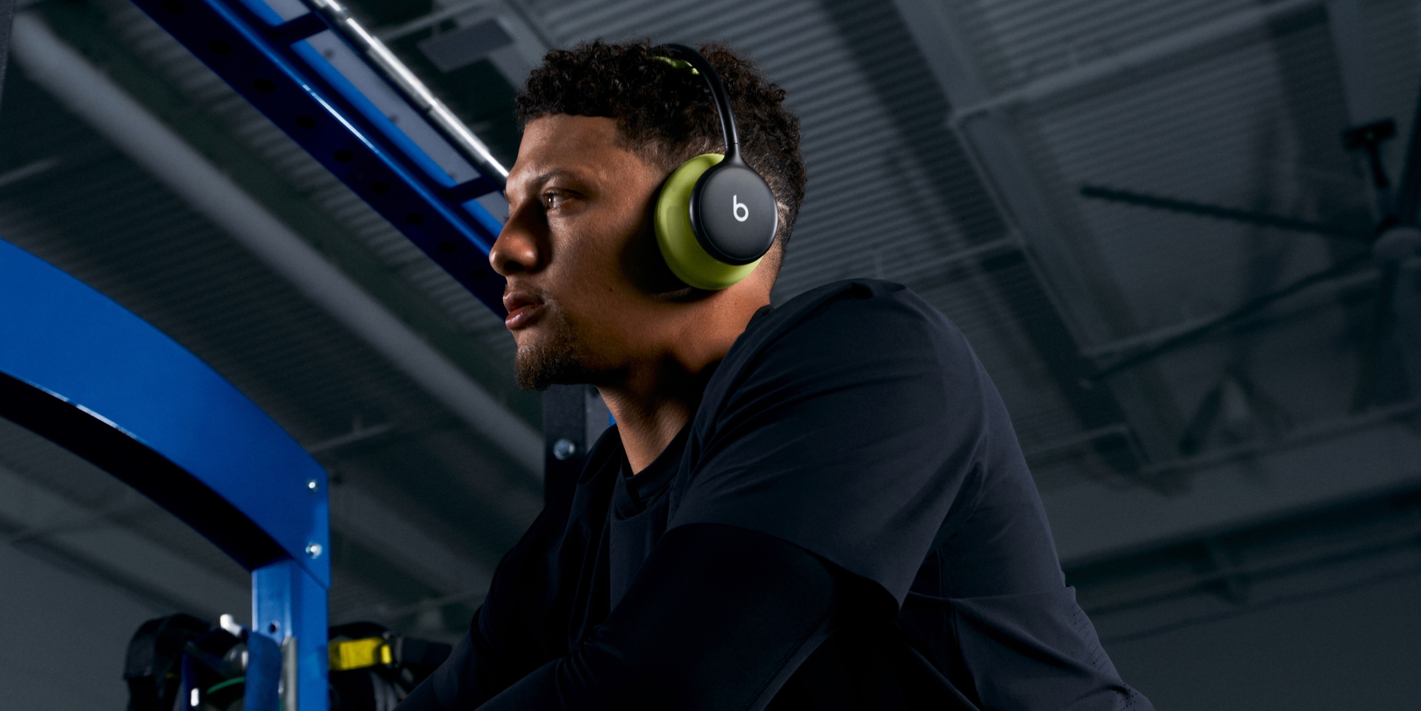 Patrick Mahomes wearing Beats 360 headphones while working out at a gym.