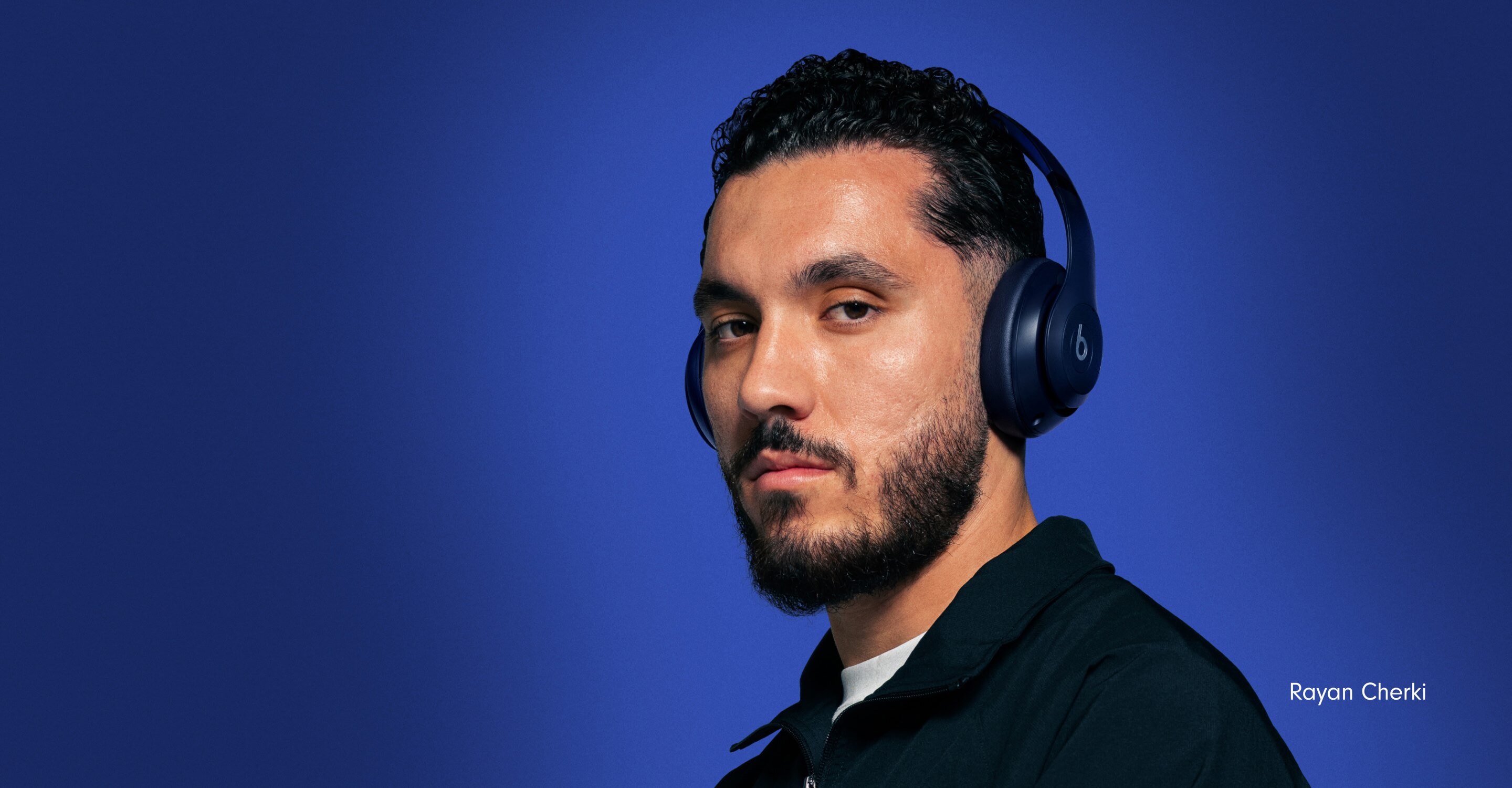 Footballer Rayan Cherki wearing Beats Studio Pro headphones in Navy against a deep blue background, with the French text "Étoile montante" meaning "Steal The Show."