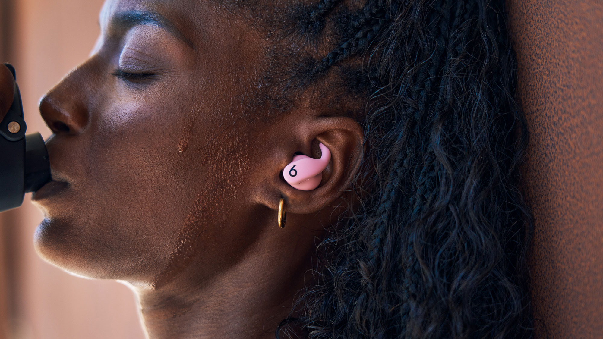 Person wearing Powerbeats Fit earbuds