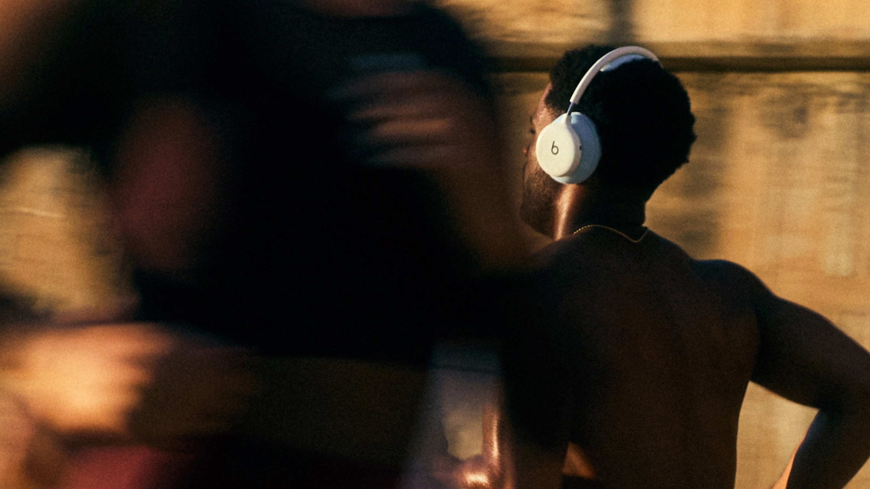 Person running while wearing Beats 360 headphones