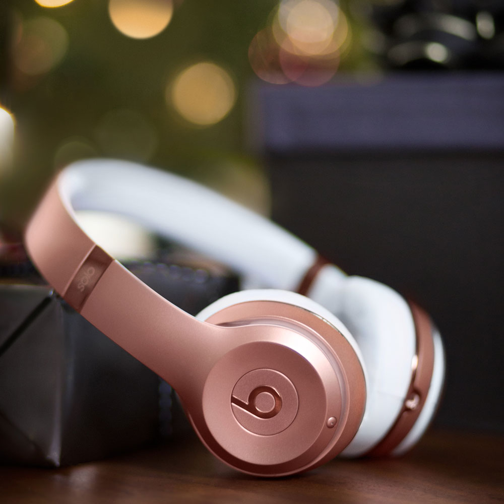 Beats Solo3 Wireless headphone in Rose Gold laying on a table
