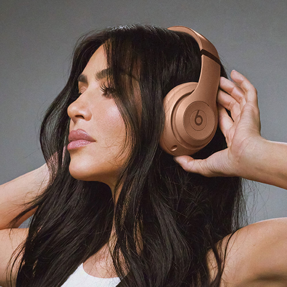 Kim Kardashian with Beats Studio Pro in Dune listening to music.