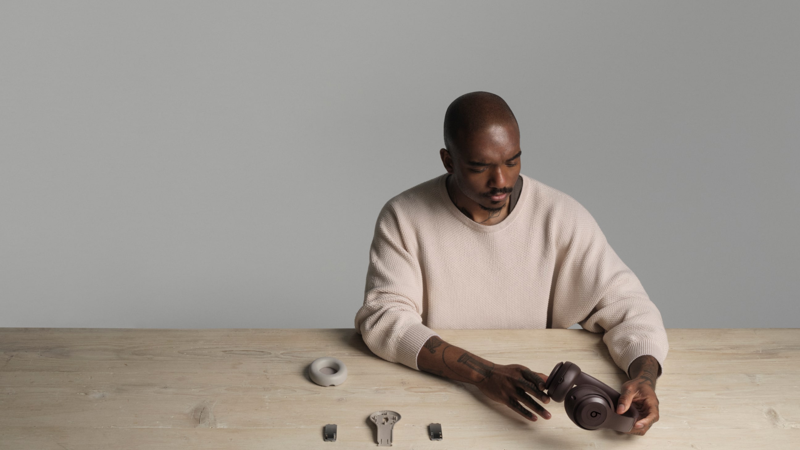 Samuel Ross holding Beats Studio Pro Wireless Headphones in the color Deep Brown